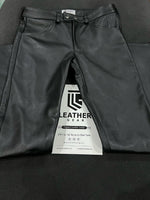 Load image into Gallery viewer, Classic gay leather pants styled with harness and boots – front view
