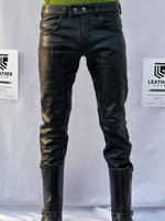 Load image into Gallery viewer, Leatherman posing in full-grain cowhide leather jeans with low-rise cut – front angle
