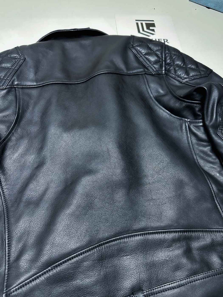 Black leather jacket on a white background with a brand logo visible.