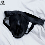 Charger l&#39;image dans la galerie, Front angled view of black leather jockstrap with visible elastic waistband and bold masculine silhouette
