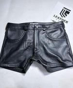 Lade das Bild in den Galerie-Viewer, Flat lay front of classic leather shorts – black cowhide, leather short shorts with buttoned waistband for gay fetishwear
