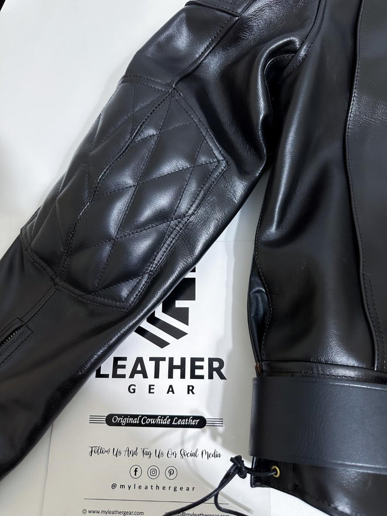 Close-up of a black leather jacket with visible branding on a white background