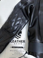 Load image into Gallery viewer, Close-up of a black leather jacket with visible branding on a white background
