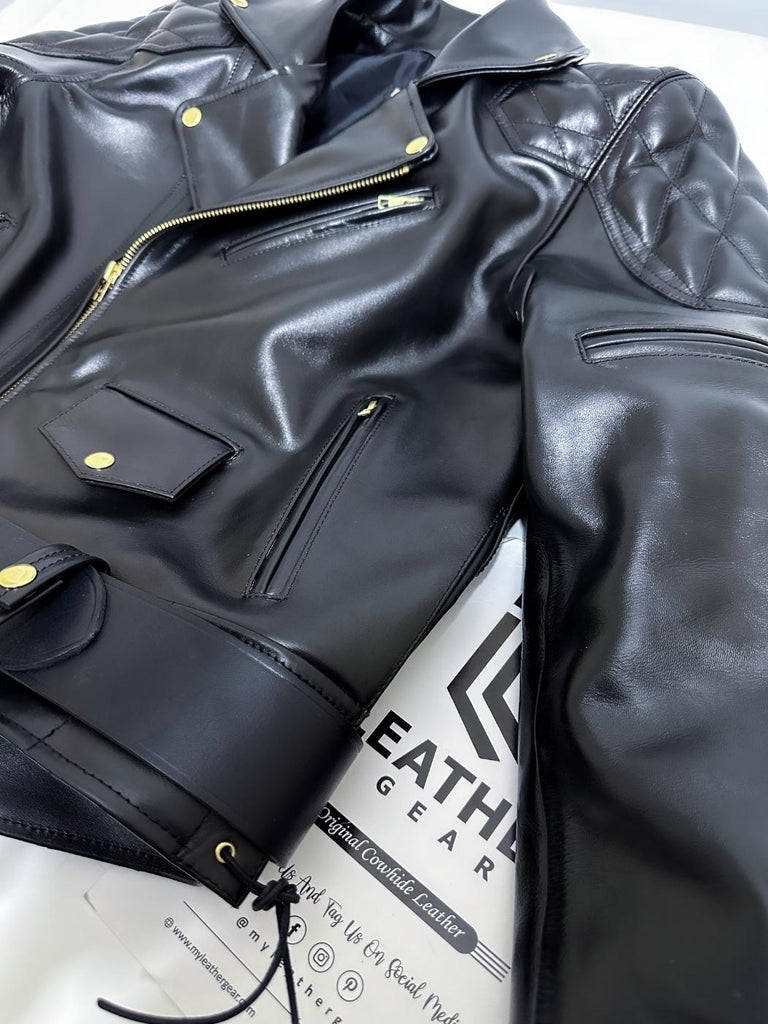 Black leather jacket with gold zippers on a white background