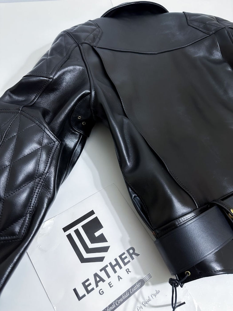Black leather jacket on a white surface with 'Leather Gear' branding.