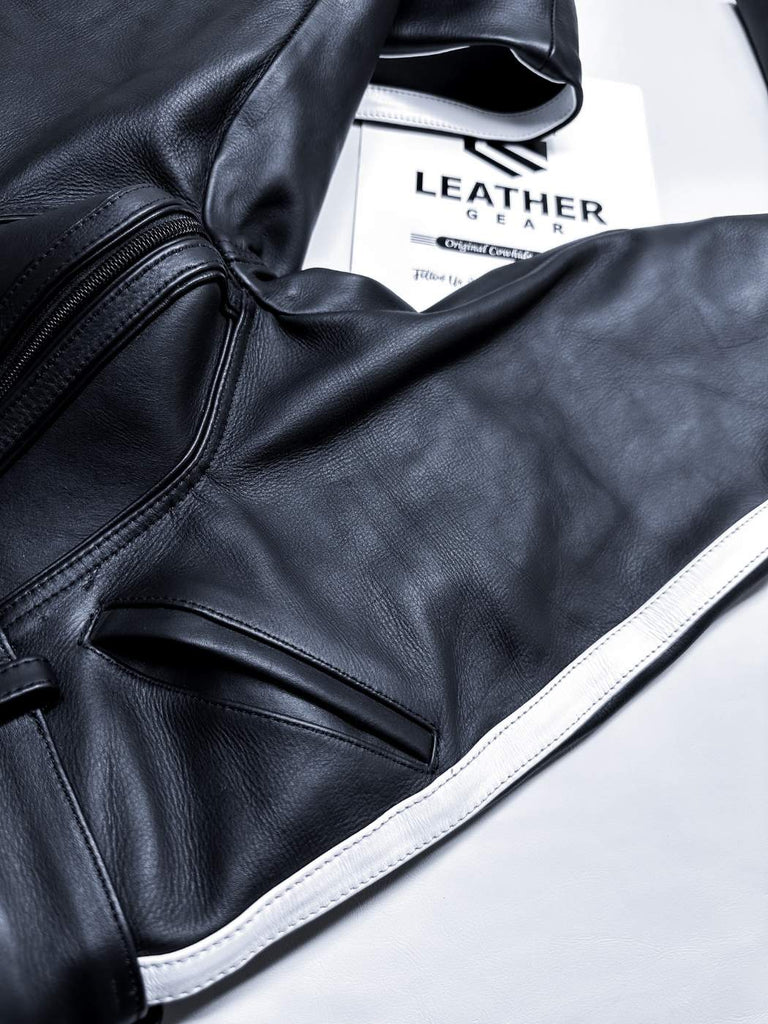 Close-up of a black leather jacket with a visible brand label on a white background