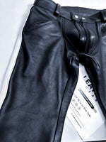 Charger l'image dans la galerie, Black leather pants with a visible brand tag on a light gray background
