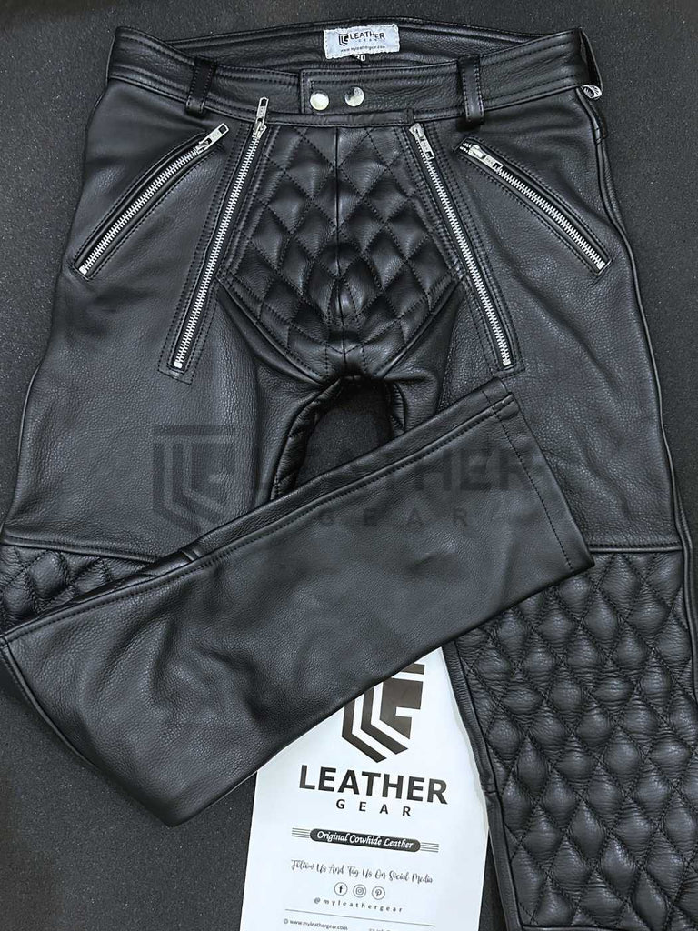 Flat lay front view of leather padded pants – double zip fly and codpiece detail in black full-grain leather