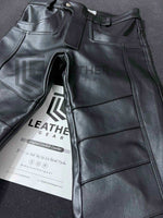 Load image into Gallery viewer, Black leather fetish jeans pants laid flat showing front zipper and pockets
