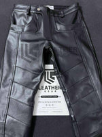 Load image into Gallery viewer, Folded flat view of tight fit black leather pants for gay leathermen
