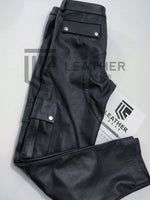 Load image into Gallery viewer, Folded side view showing dual-snap cargo pockets – leather pants men wear for fetish shop and party looks
