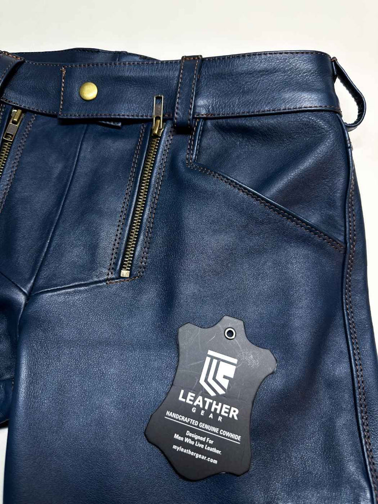 Blue leather pants with a visible brand tag on a white background