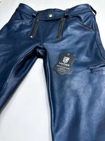 Charger l'image dans la galerie, Blue leather pants with a brand tag on a white background
