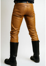 Load image into Gallery viewer, Back view of tan leather pants showing rear fit and stitching – leather uniform jeans for gay fetishwear and BLUF style
