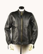 Lade das Bild in den Galerie-Viewer, The Rider Leather Jacket in black full-grain leather, showcasing its long silhouette, YKK zipper, and stand collar design — ideal for BLUF and gay leather gear.
