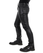 Load image into Gallery viewer, Gay leatherman modeling slim-fit leather pants with button front – side angle
