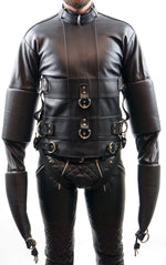 Lade das Bild in den Galerie-Viewer, Front view of Leather Bondage Straitjacket with arms down, model standing in relaxed pose
