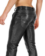 Load image into Gallery viewer, Left side angle of leather fetish pants showing slim fit and harness styling
